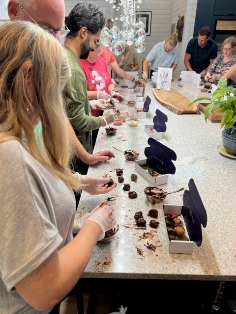 A group of people making chocolates