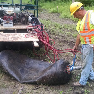 worker with crushed tank