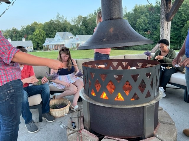 A group of people sitting around a fire pit