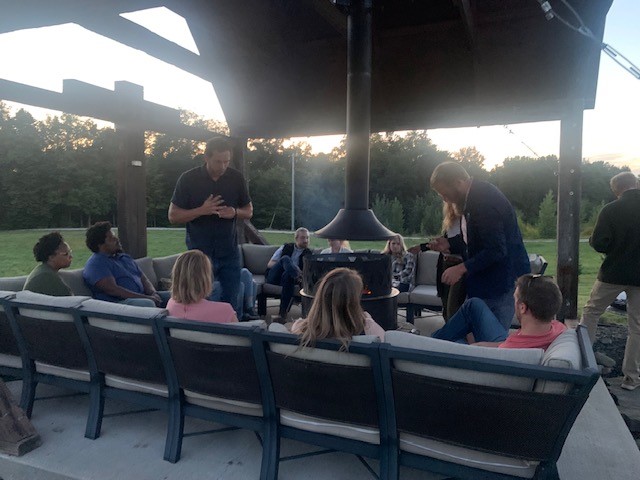 A group of people sitting around a fire pit