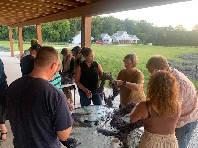 A group of people around a table making wreaths