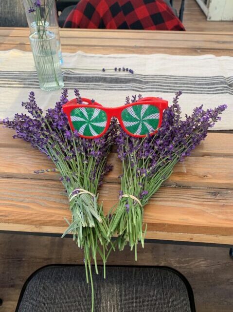 A bunch of lavender with sunglasses on a table