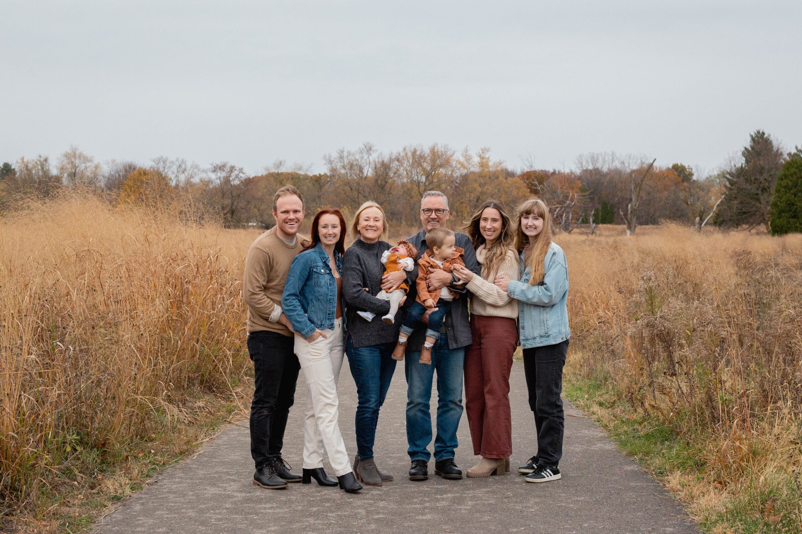 group of 6 adults with the middle two holding children